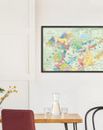 The De Long Wine Map of Austria and Hungary Framed hangs on a white wall above a small dining table with chairs.