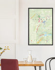 The De Long Wine Map of Germany Framed hangs on a white wall above a dining table with yellow flowers.