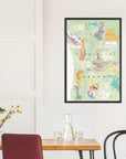 The De Long Wine Map of the Pacific Northwest Framed hangs above a dining table with chairs and a vase on a white wall.
