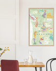 A De Long Wine Map of the Pacific Northwest Framed hangs above a modern dining table on a crisp white wall.