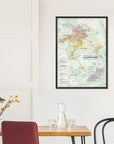 A De Long Wine Regions of Champagne Framed map (A1, wood frame) hangs above a dining table with chairs and a carafe.
