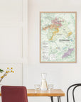 De Long's Wine Regions of Champagne Framed map in A1 size displayed above a dining table with chairs, vase, and carafe.