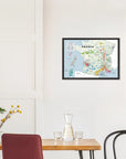 A De Long Wine Regions of France Vino One Framed map hangs above a dining table with chairs, carafe, and yellow flowers.