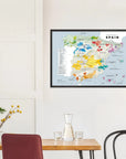 A De Long Wine Regions of Spain Vino One Framed print hangs above a minimal dining table with chairs.