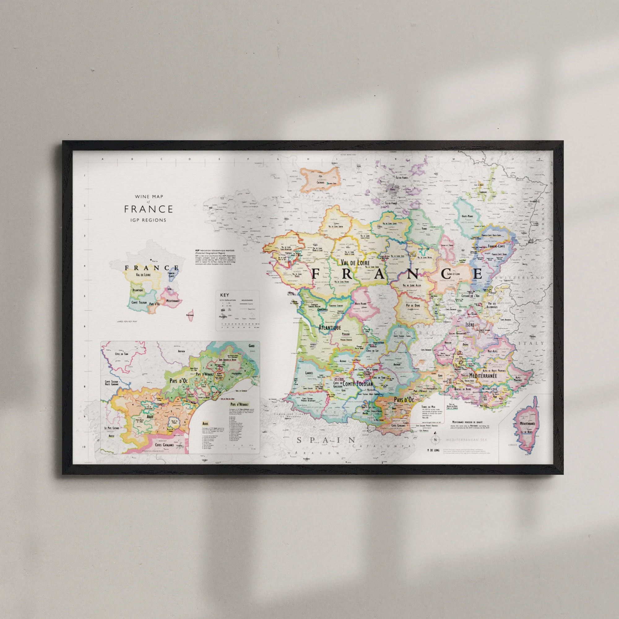 The Wine Map of France IGPs Framed features a wood frame and displays France’s wine regions, major cities, IGPs, labeled borders, and neighboring countries with colorful detail; insets provide close-up views of key areas.