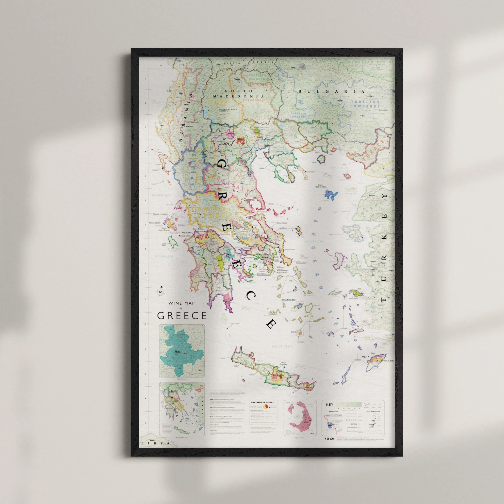 De Long Wine Map of Greece Framed, with PDO and PGI regions and legend, displayed on a light wall.
