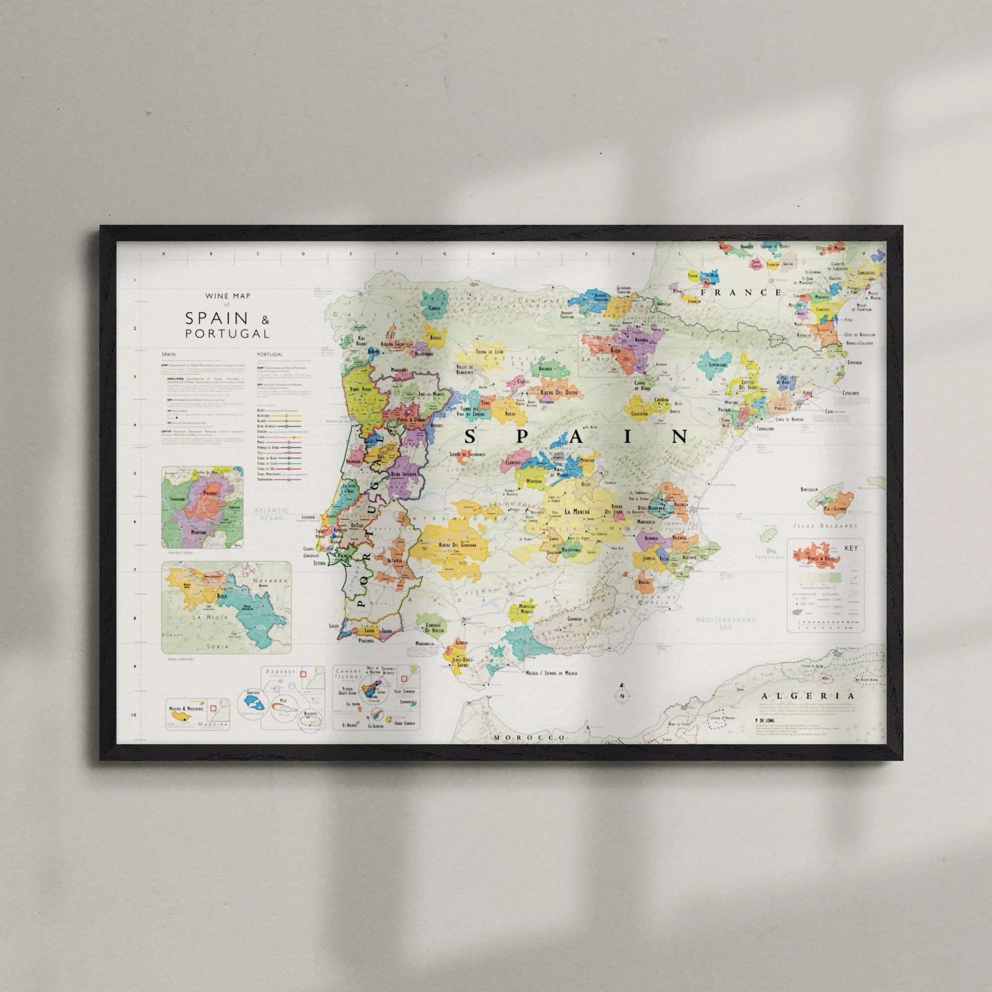 De Long Wine Map of Spain &amp; Portugal Framed, 24x36", with regions and cities, displayed on a wall.