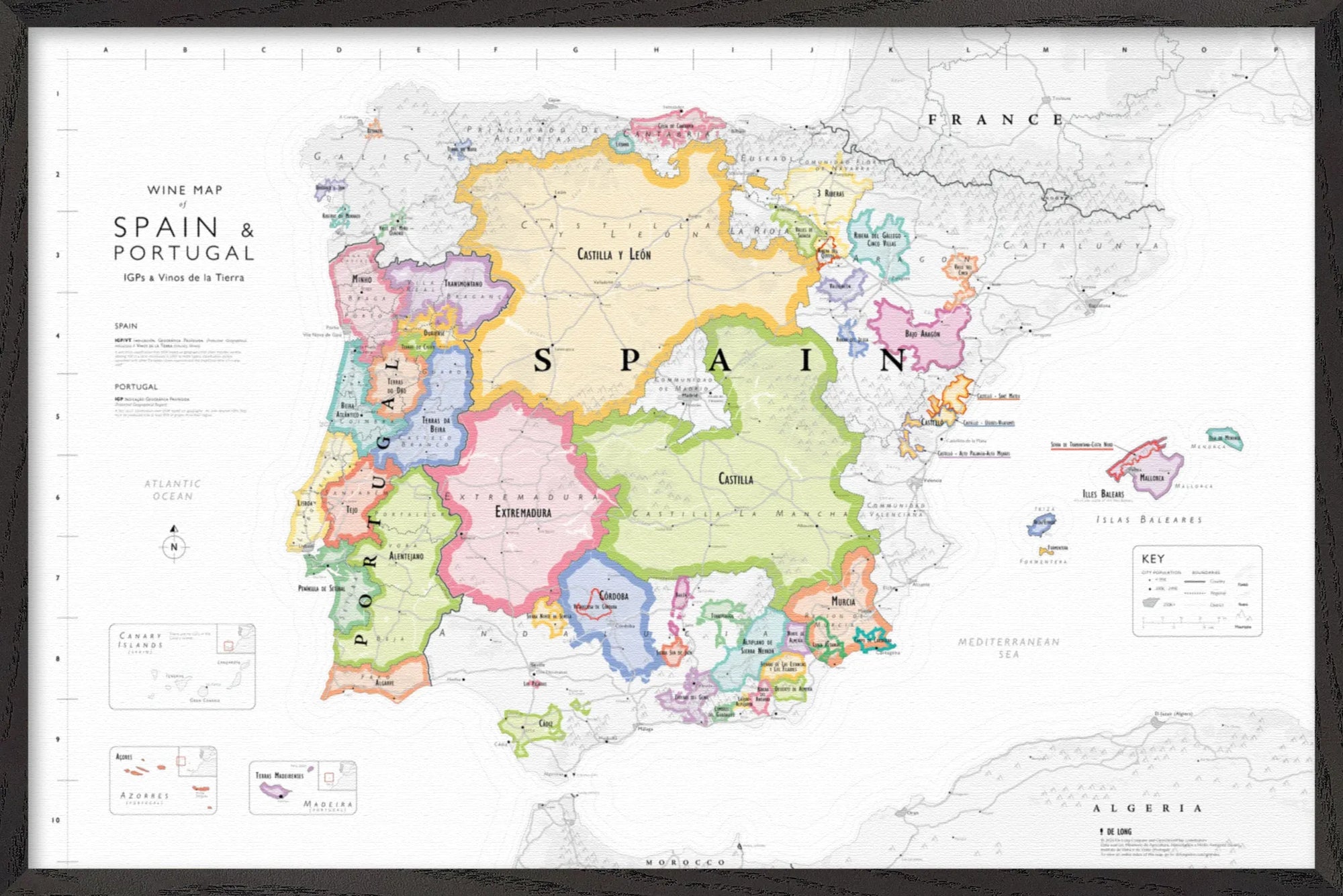 The Wine Map of Spain & Portugal IGPs Framed displays vibrant wine regions, including IGPs, with labeled borders, cities, and seas. Features a legend and scale—ideal as a stylish wood-framed display for wine enthusiasts.